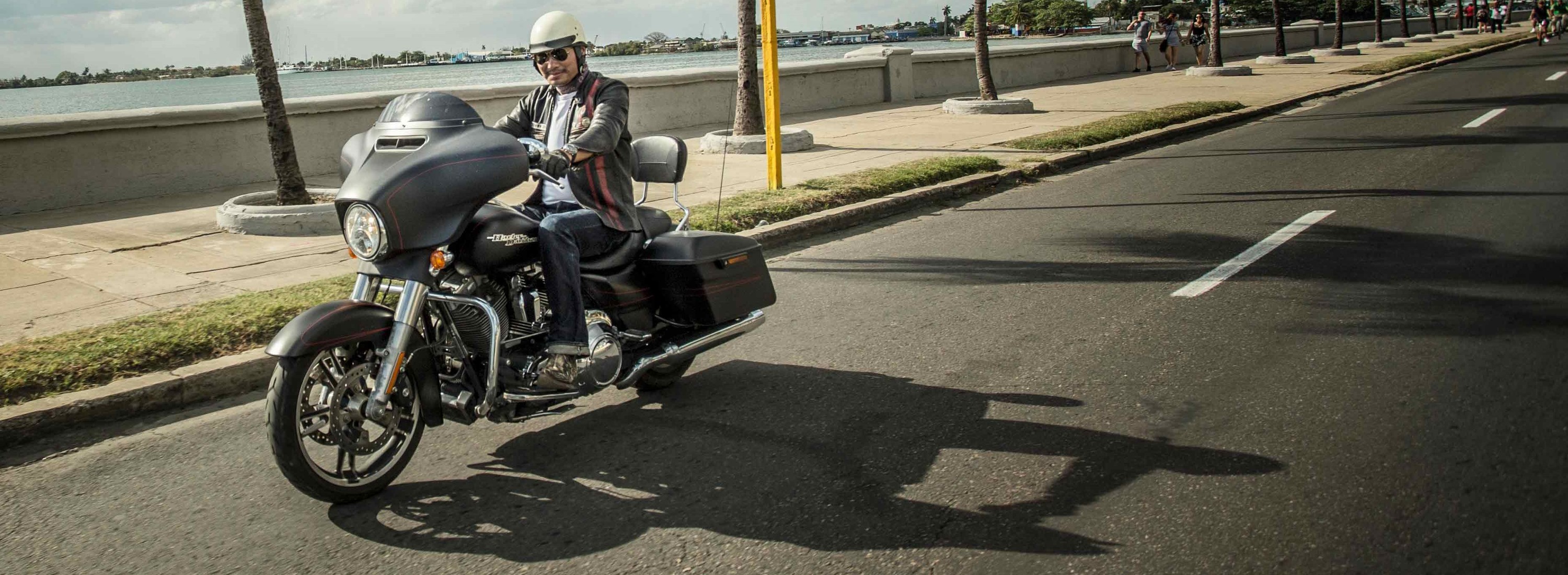 Rider cruising on a Harley-Davidson motorcycle.